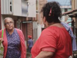 Two neighbors talk on the street