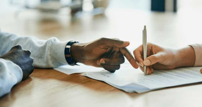 Hands signing legal contract