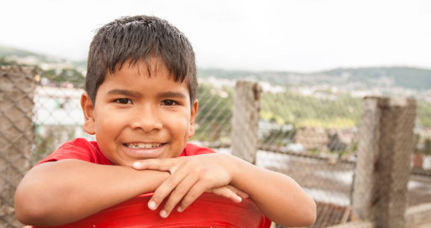 School-aged child smiles to the camera