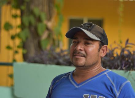 Migrant middle-aged man speaking into the camera